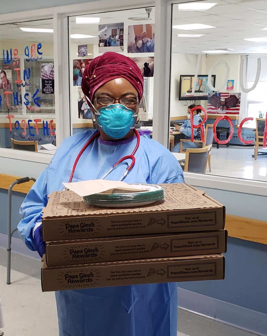 nurse holding Papa Gino's pizzas